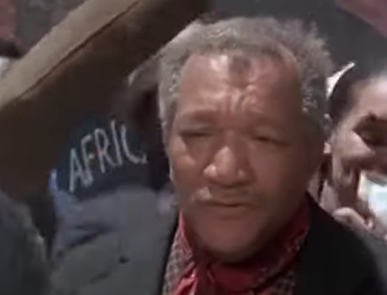 Screenshot of Redd Foxx talking and looking at front - from Cotton Comes To Harlem (1970)