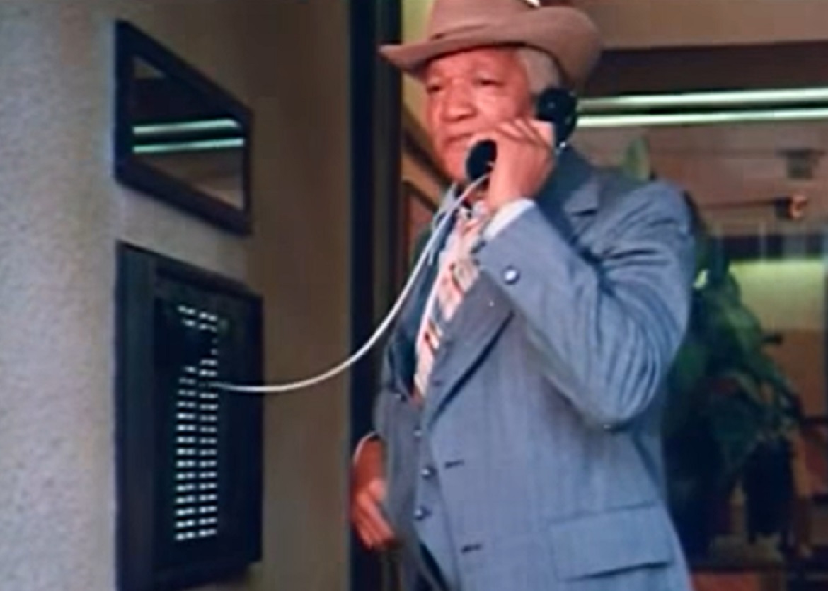 Screenshot of Redd Foxx with brown hat talking on the phone  - from Norman... Is That You?