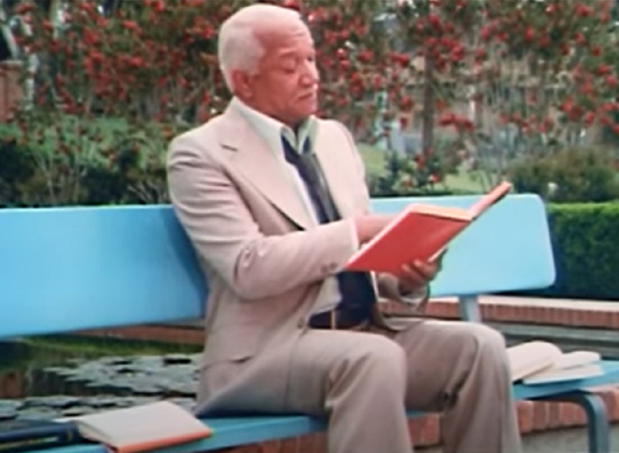 Screenshot of Redd Foxx reading a book - from Norman... Is That You? (1976)