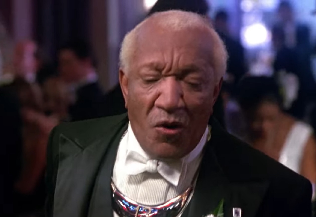 Screenshot of Redd Foxx in suit ,looking down - from Harlem Nights (1989)