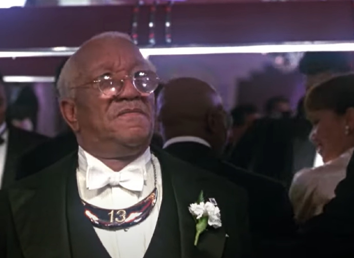 Screenshot of Redd Foxx in black suit and big glasses - from Harlem Nights (1989)