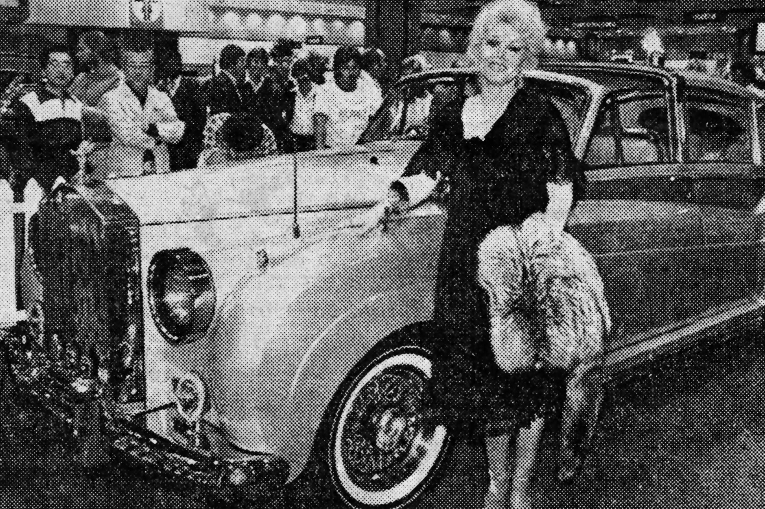 Zsa Zsa Gabor in black in front of a car