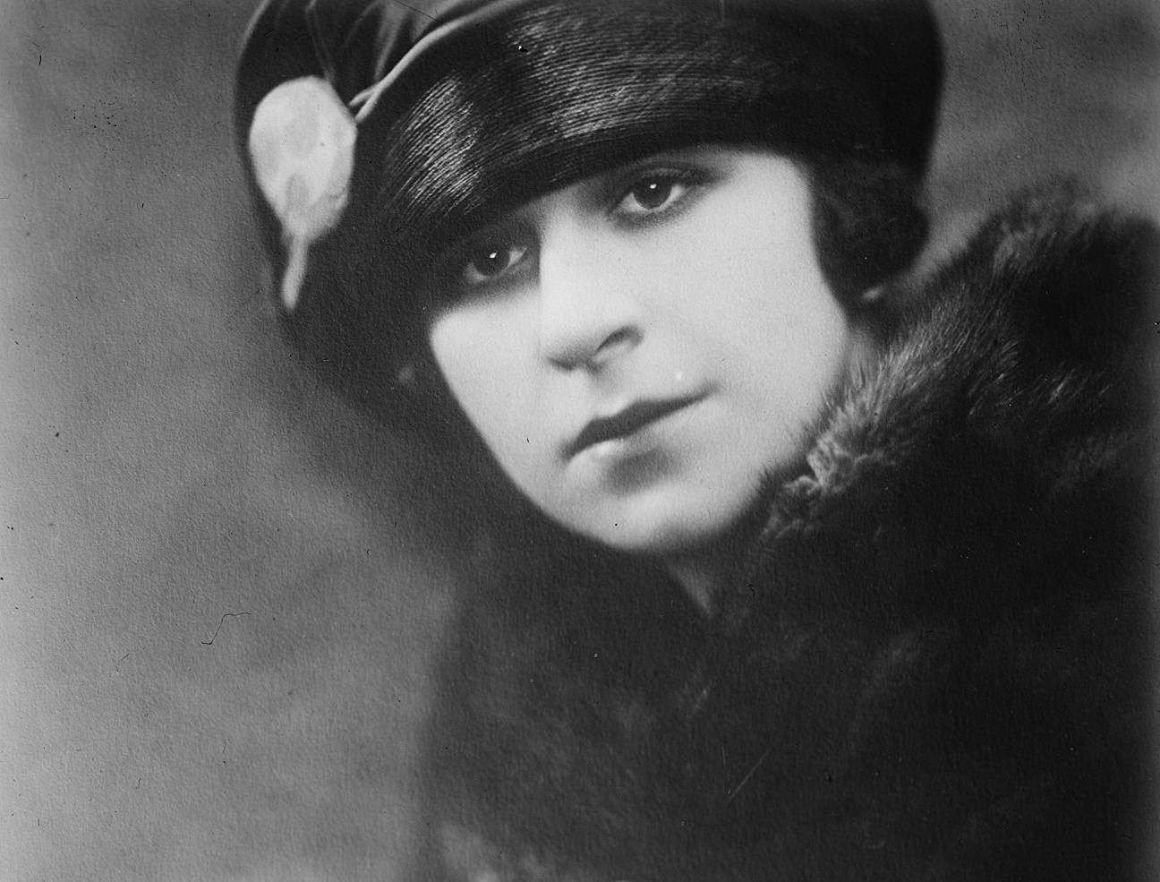 Fanny Brice in black coat and a hat