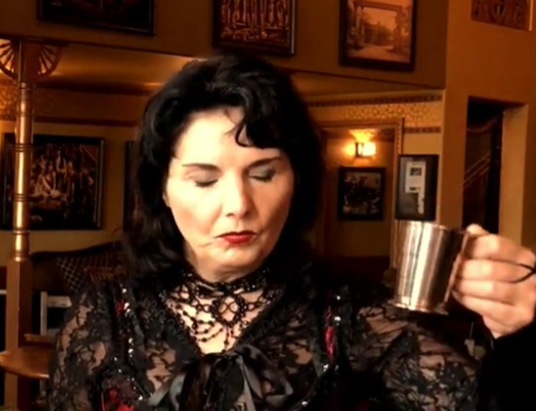 Screenshot of Big Nose Kate (Kate Horony) drinking at saloon- from One Day Only (2018/19)