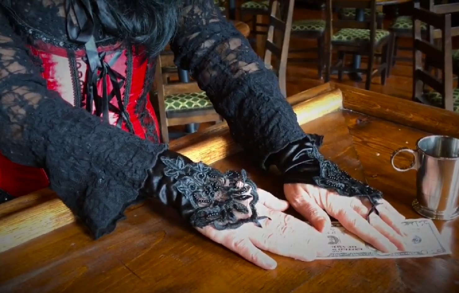 Screenshot of Big Nose Kate (Kate Horony) taking a money at bar - from One Day Only (2018/19)