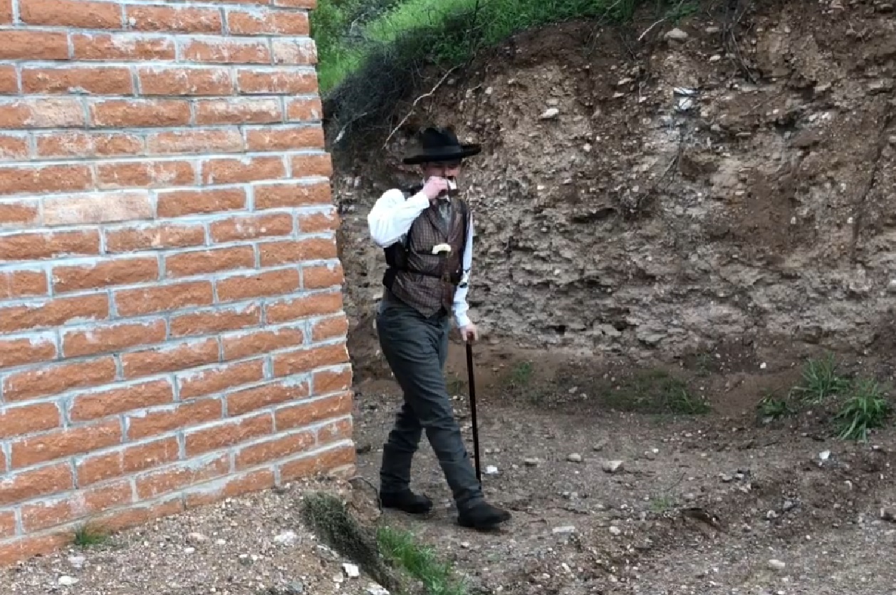 Screenshot of Doc Holliday walking ouside  - from One Day Only (2018/19)