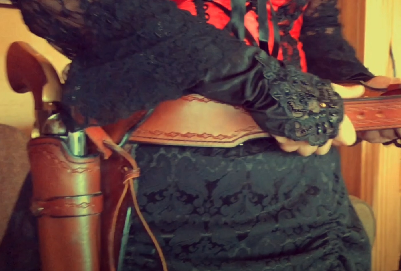 Screenshot of Big Nose Kate (Kate Horony) putting on her gun belt - from One Day Only (2018/19)