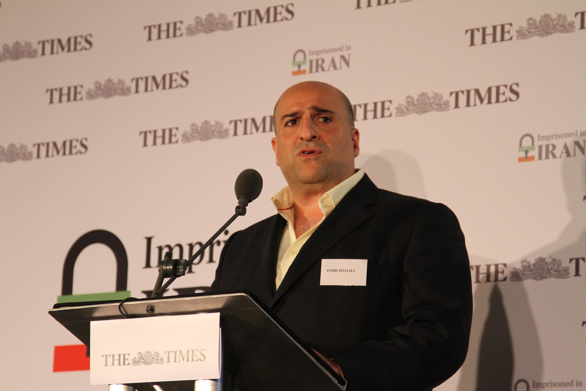 Omid Djalili reading a letter