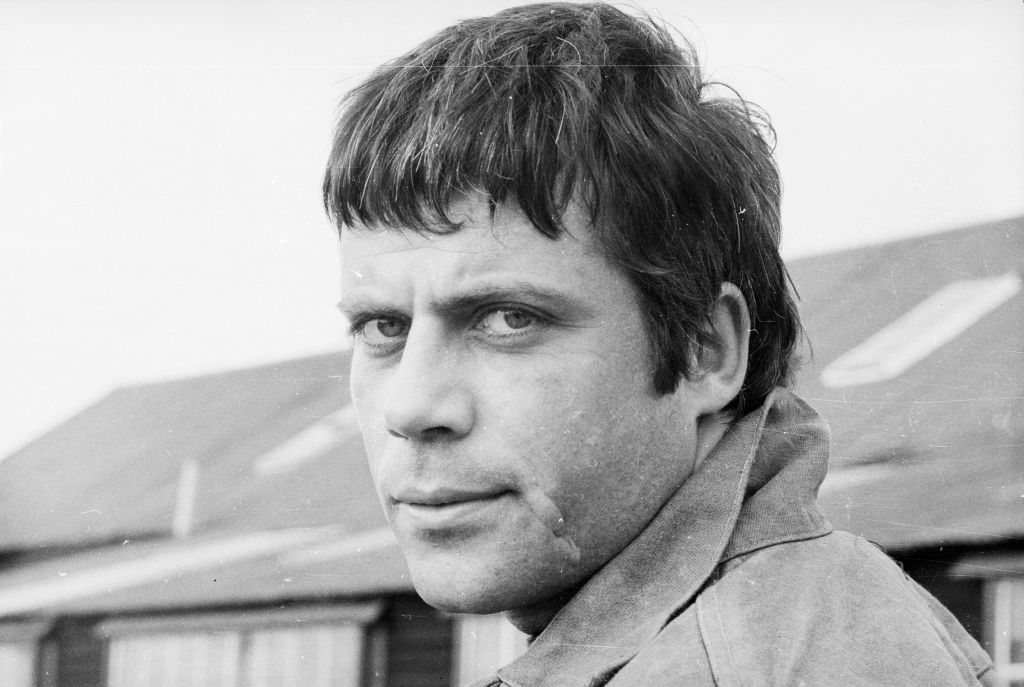 Oliver Reed in jacket looking at the camera