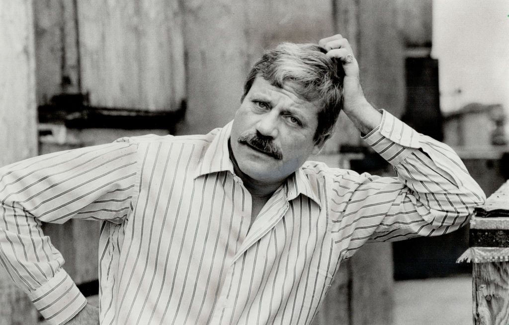 Oliver Reed in stripped shirt