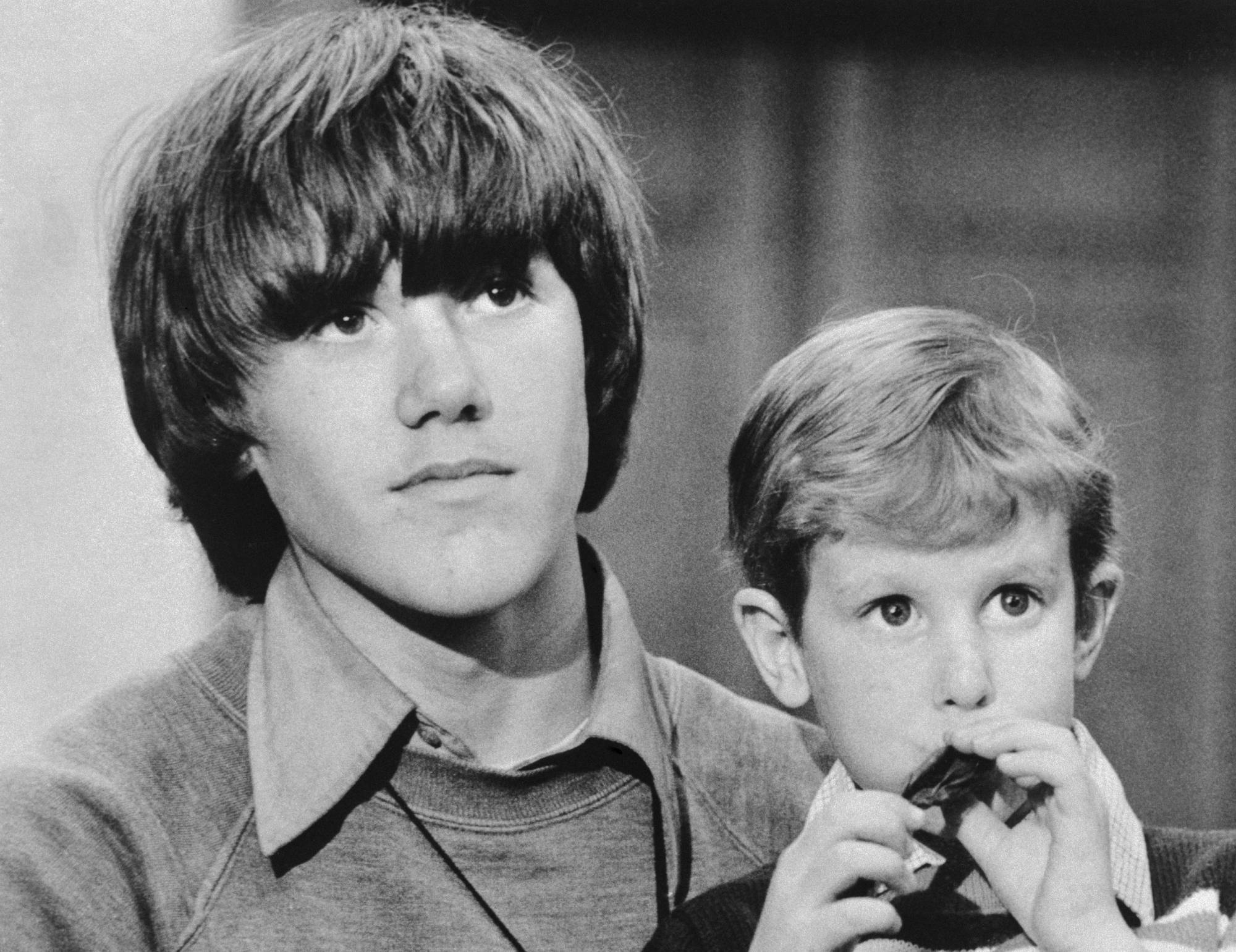 Timmy White, 5, who disappeared on Valentine's Day, sits on the lap of Steven Stayner, 14 kidnapped