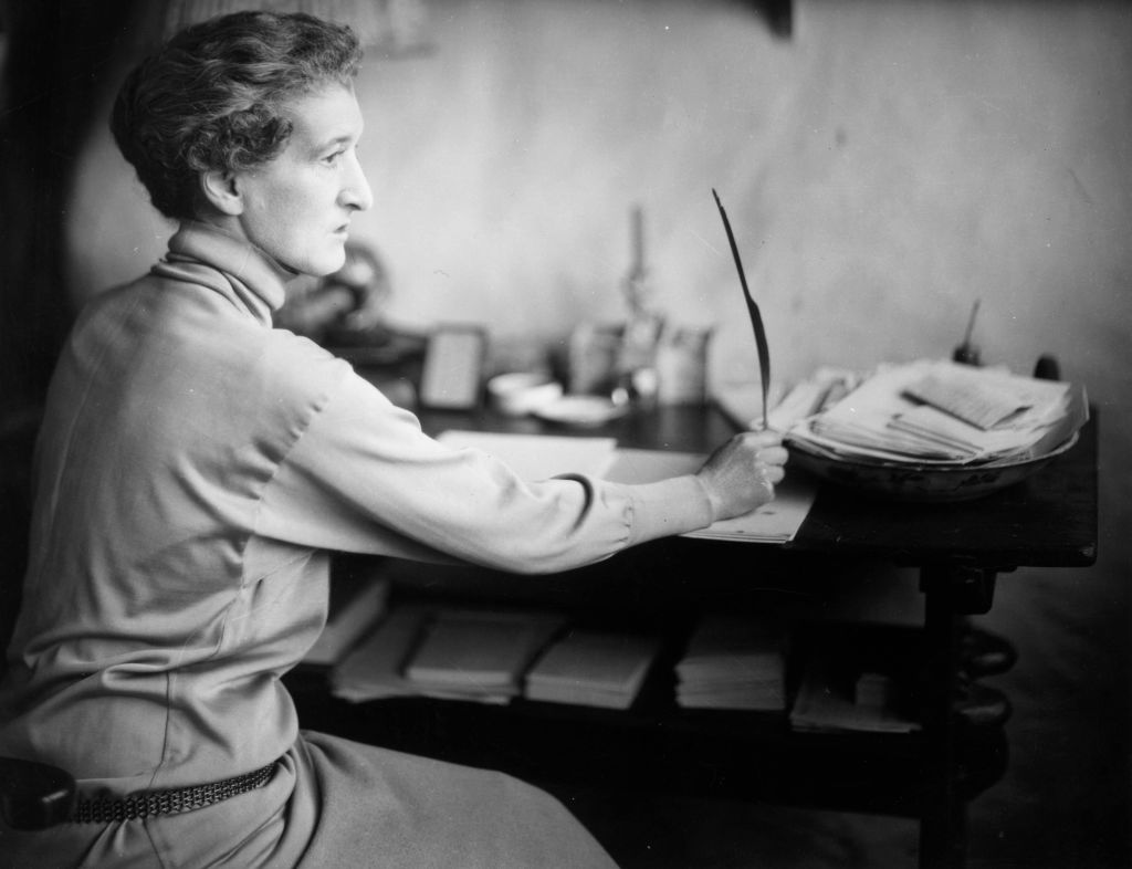 Margot Asquith writing at a desk