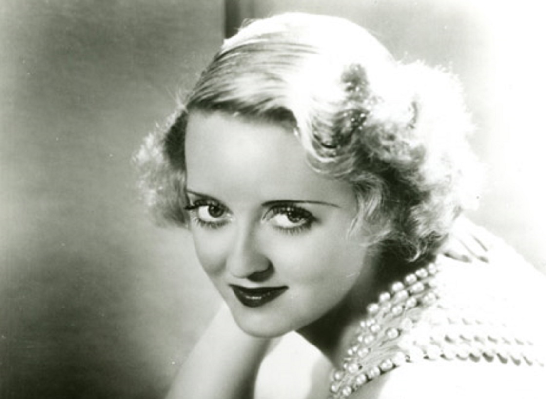 Portrait of Bette Davis looking at camera.