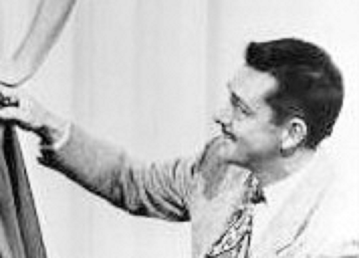 Designer William Travilla - looking at side and smiling