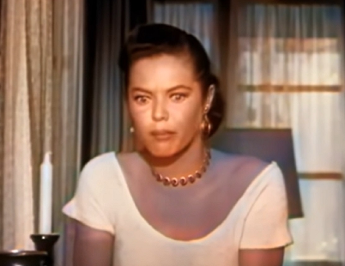Screenshot of Dona Drake looking down upset - from Kansas City Confidential (1952)