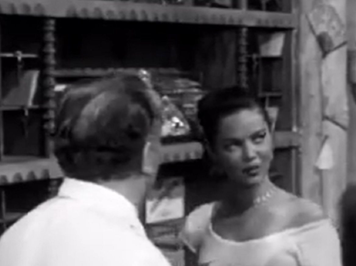 Screenshot of Dona Drake looking at side and talking with other man - from Kansas City Confidential (1952)