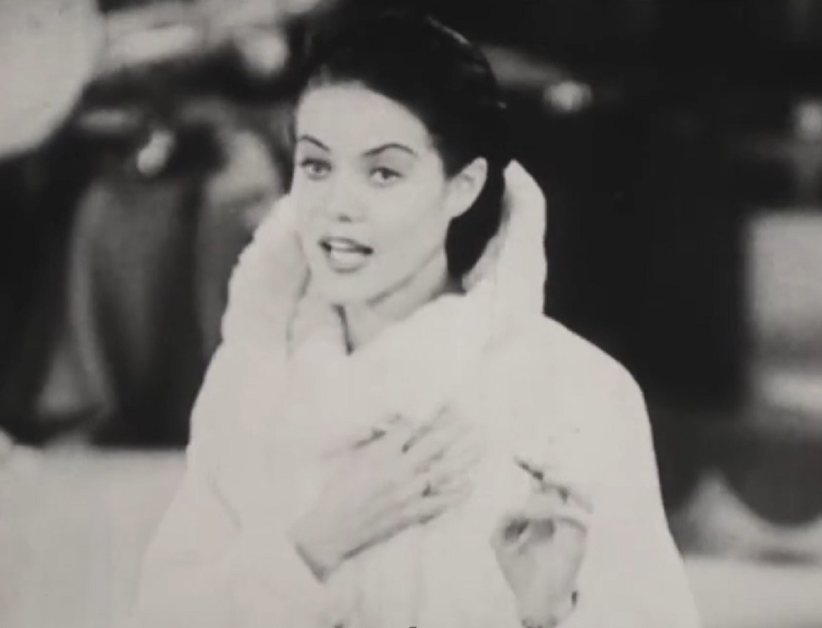 Screenshot of Dona Drake wearing white coat and talking - from Sweet Shoe (1938)