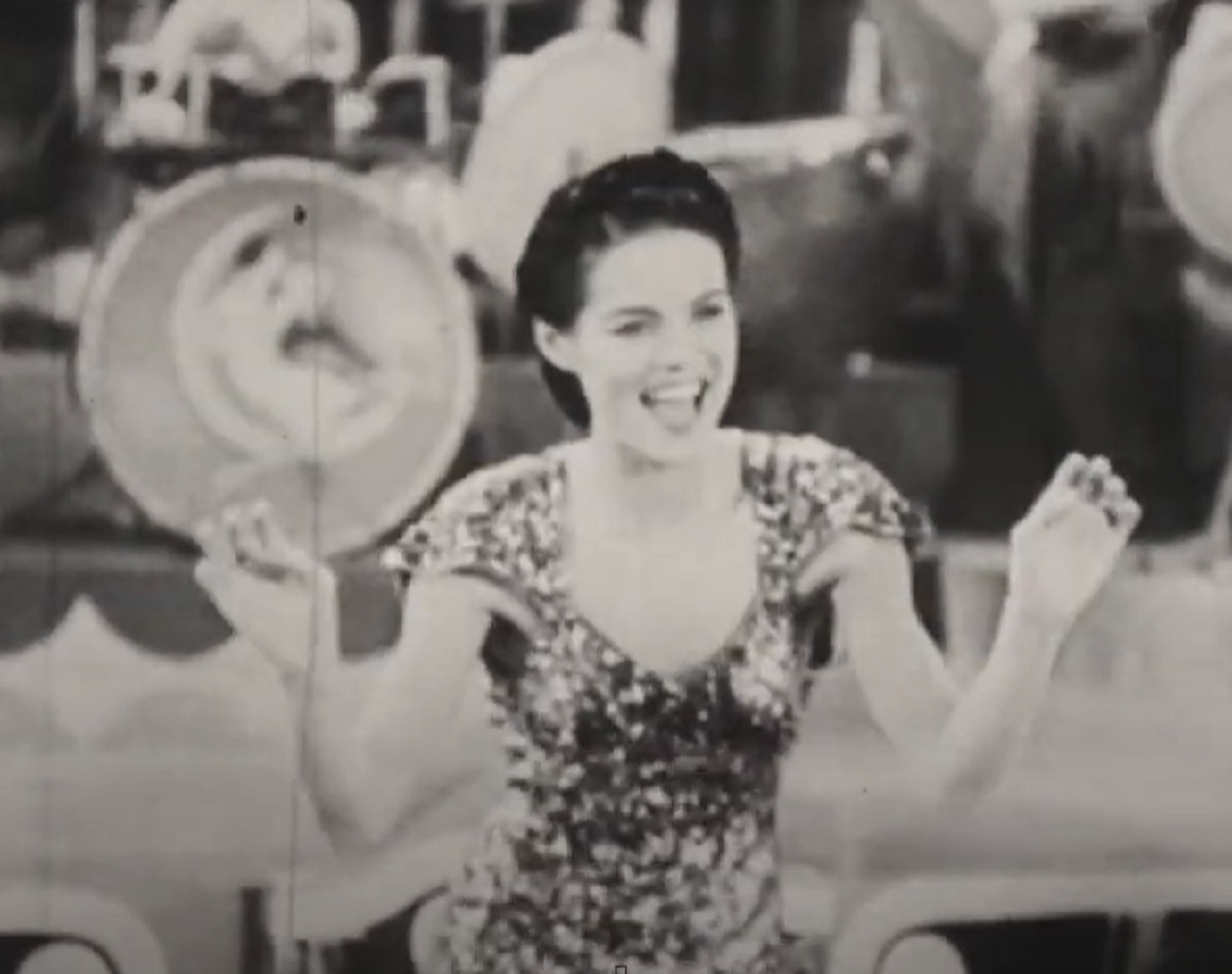 Screenshot of Dona Drake dancing and singing on stage - from Sweet Shoe (1938)