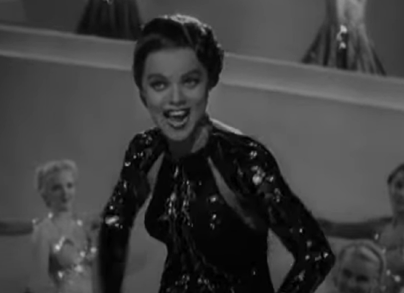 Screenshot of Dona Drake smiling at camera - from Strike Me Pink (1936)