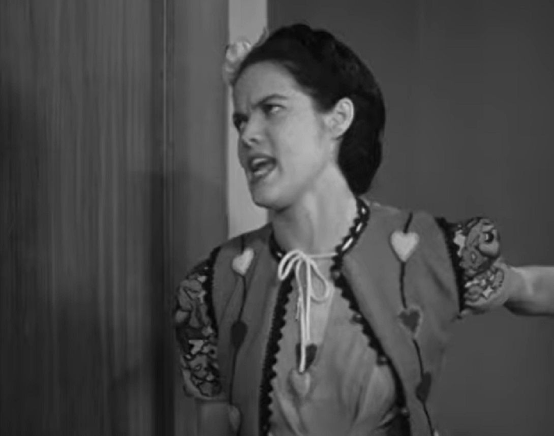 Screenshot of Dona Drake looking at side with upset face - from Rita Rio And Her Orchestra (1939)
