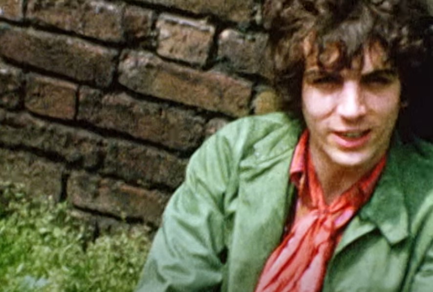 Syd Barrett in green  shirt  and pink scarf