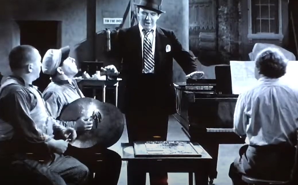 Ted Healy wearing suit and hat