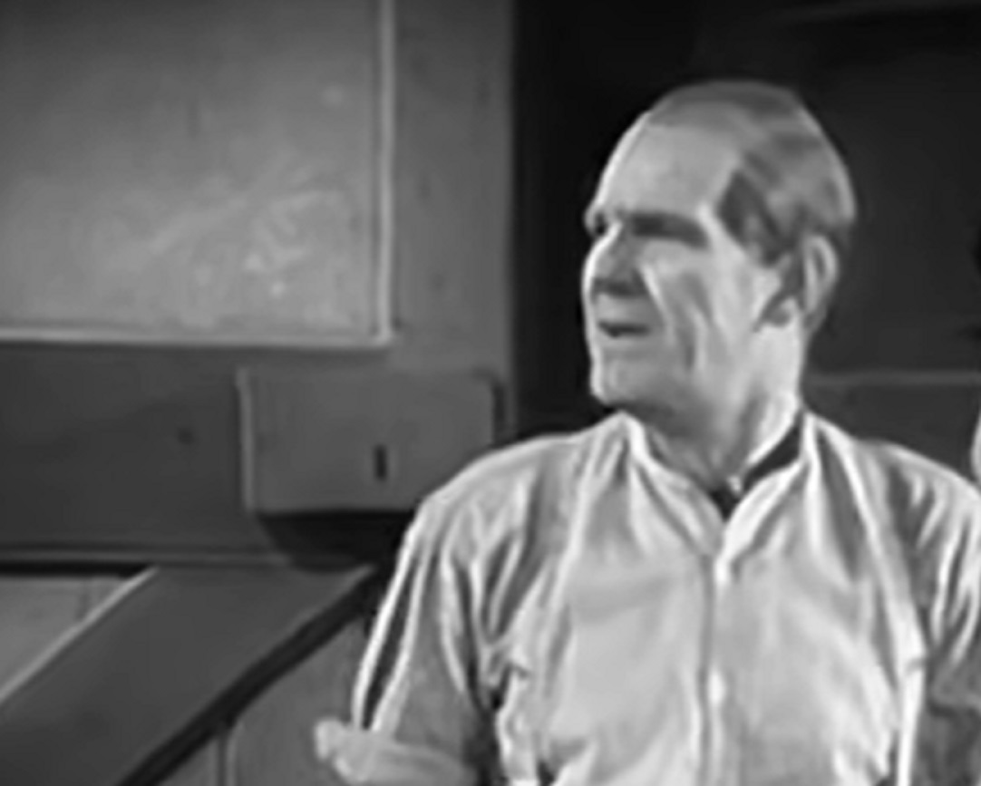 Screenshot of Will Hay looking at side in white shirt - from Where's That Fire? (1940)