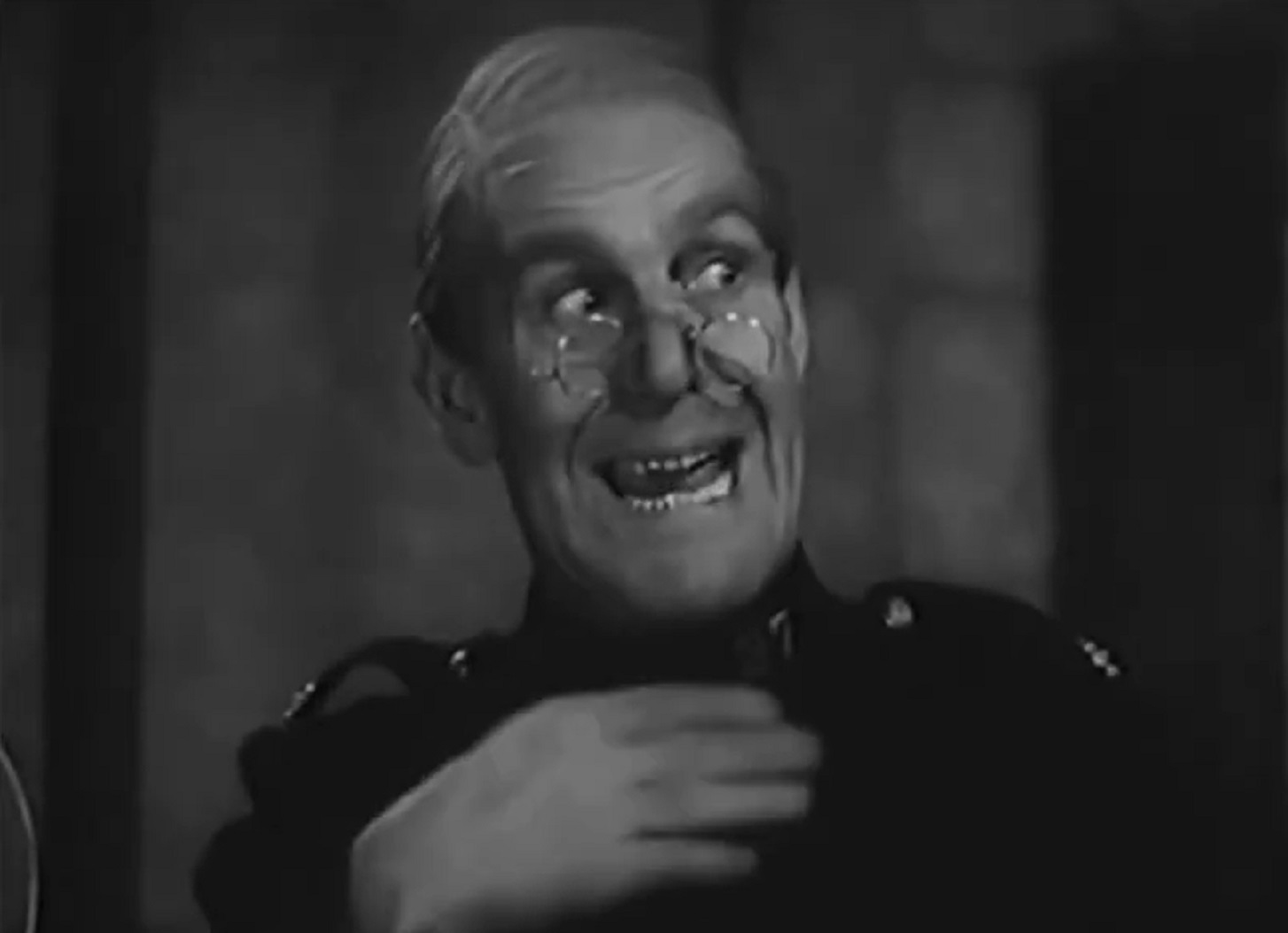 Screenshot of Will Hay looking at side - from Ask a Policeman (1939)
