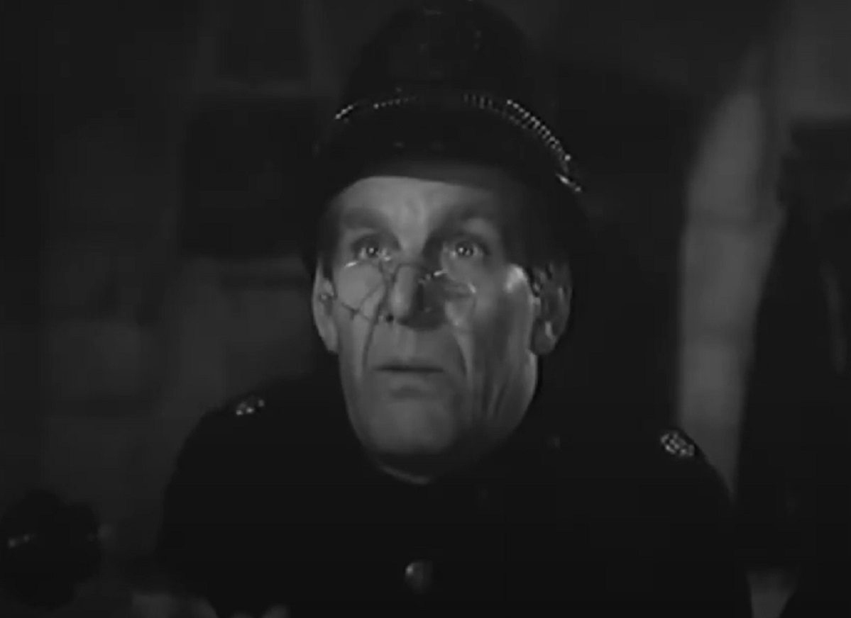 Screenshot of Will Hay looking at camera - from Ask a Policeman (1939)