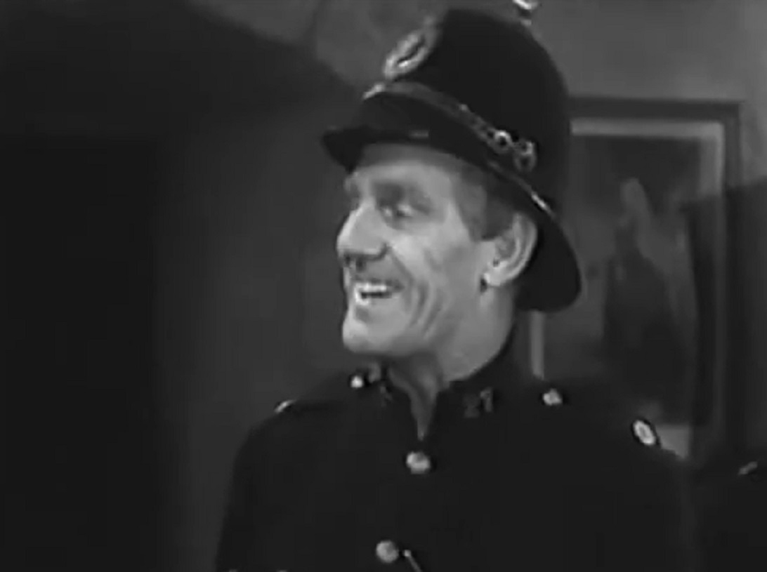 Screenshot of Will Hay smiling - from Ask a Policeman (1939)