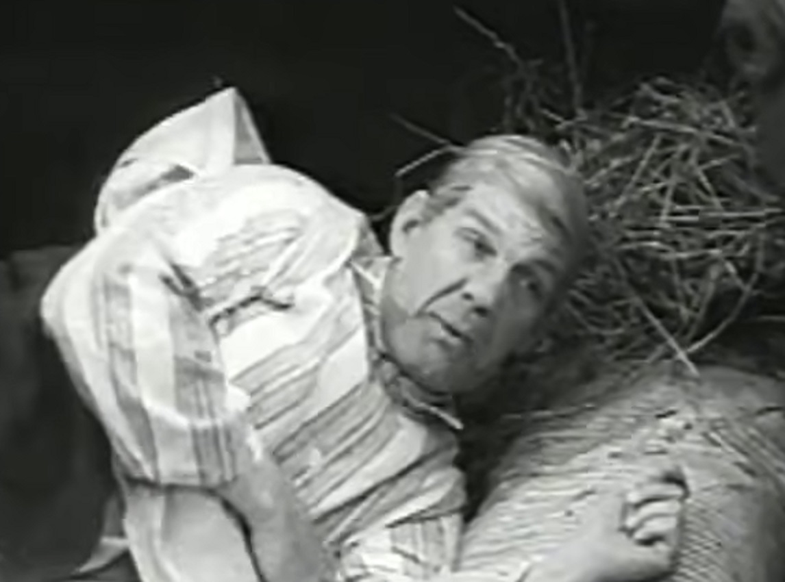 Screenshot of Will Hay laying in pajamas - from Oh, Mr Porter! (1937)