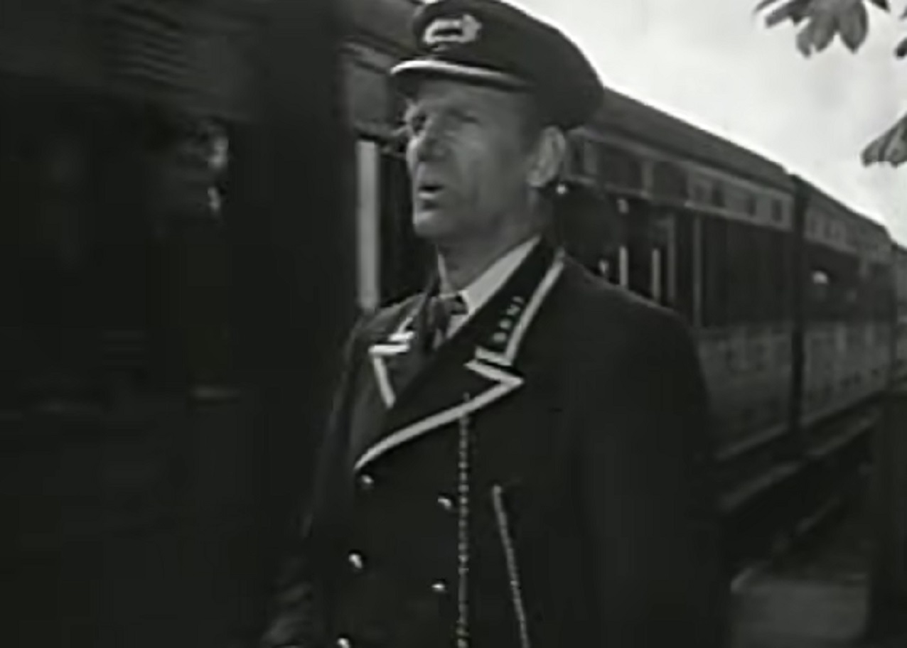 Screenshot of Will Hay looking at train - from Oh, Mr Porter! (1937)