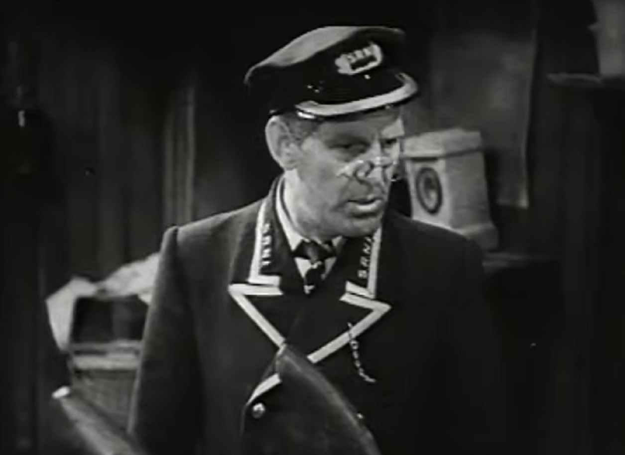 Screenshot of Will Hay in uniform looking at side - from Oh, Mr Porter! (1937)