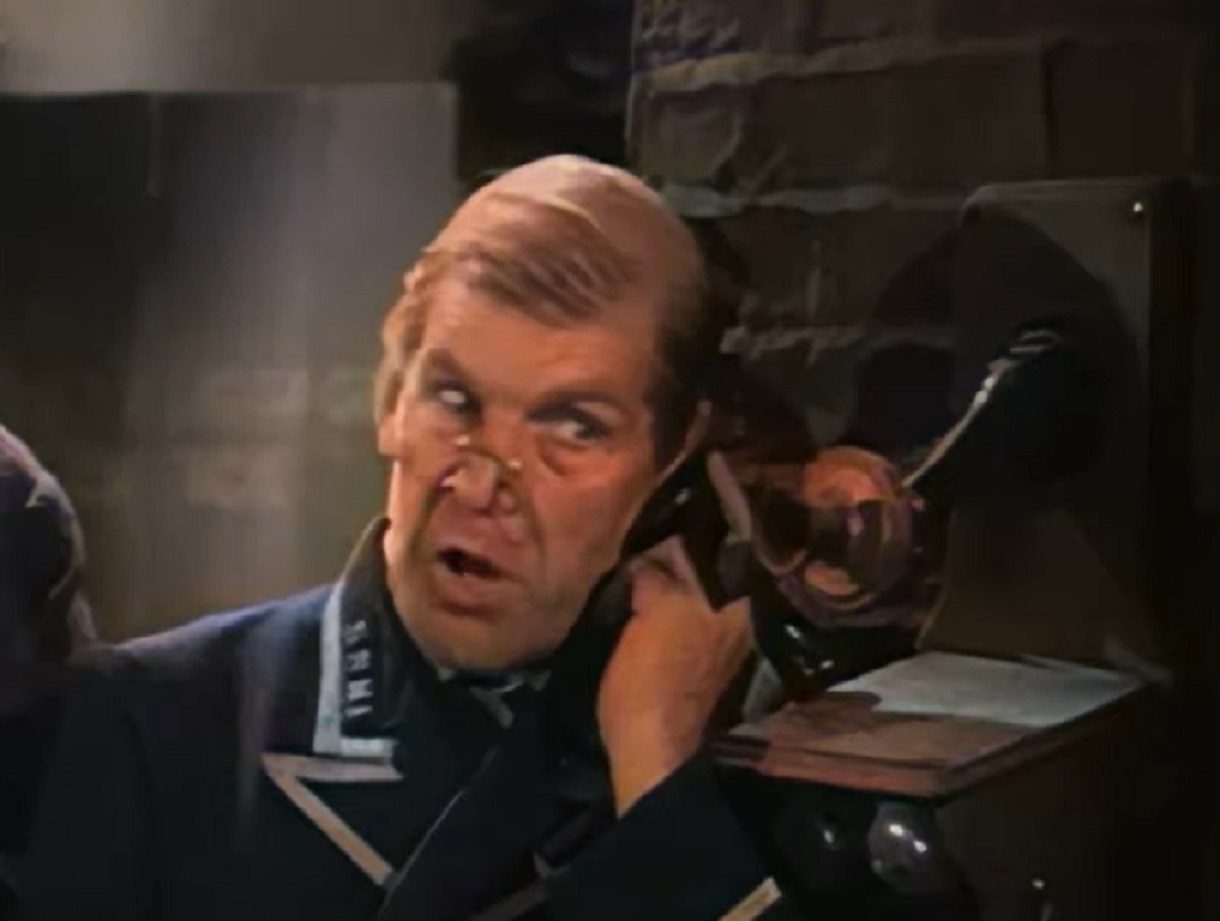 Screenshot of Will Hay talking on the phone with upset face - from Oh, Mr Porter! (1937)