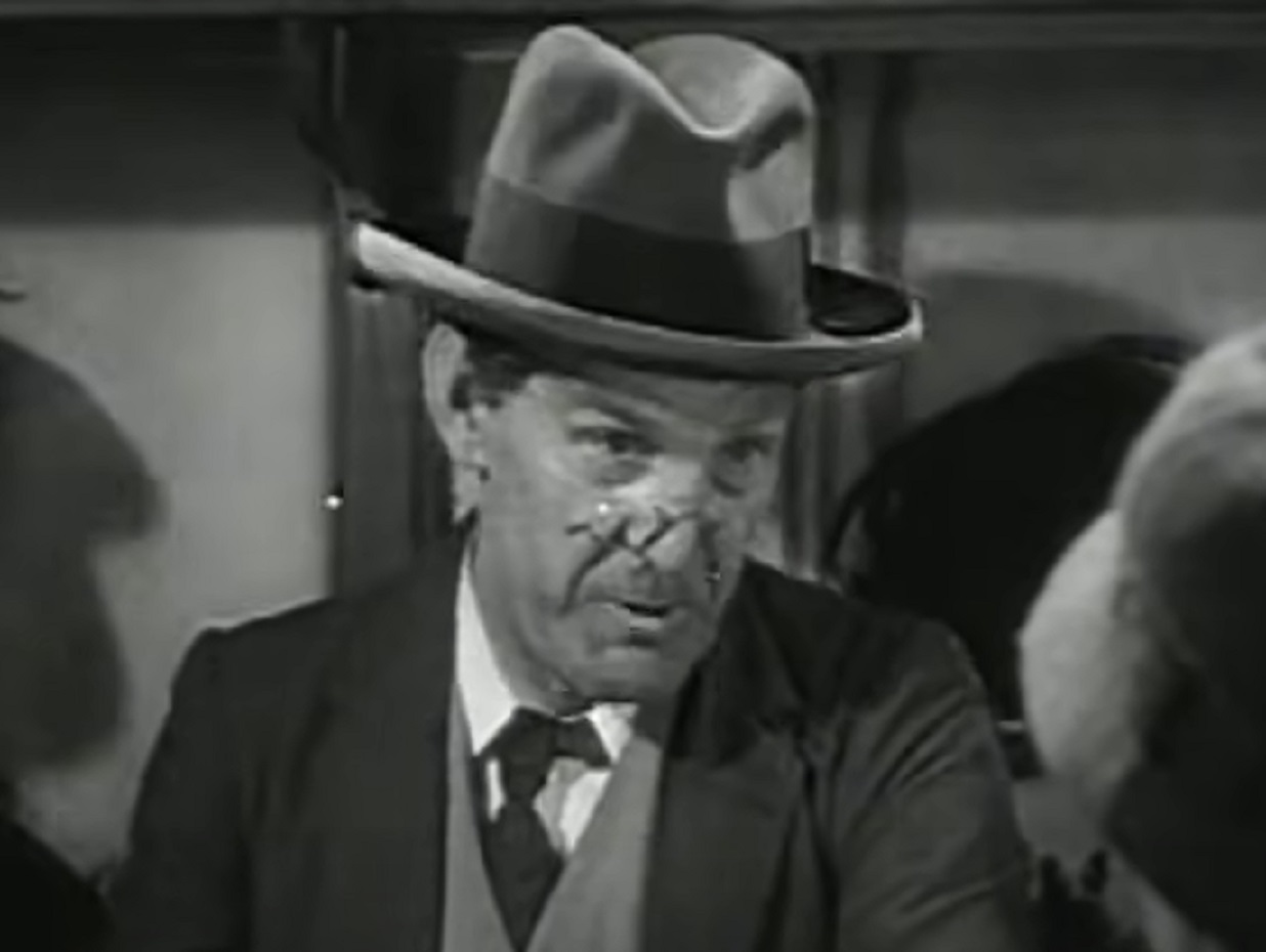Screenshot of Will Hay with hat looking at side - from Oh, Mr Porter! (1937)