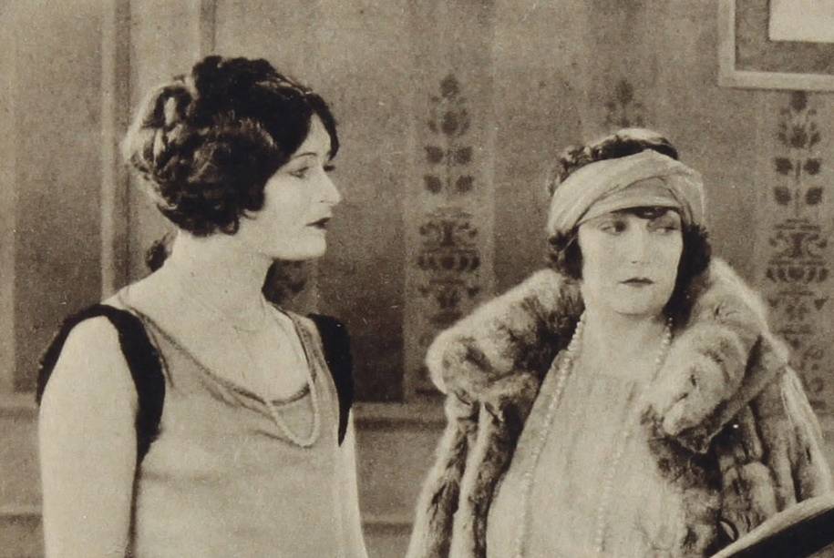 Mae Laurel in fur coat looking at right