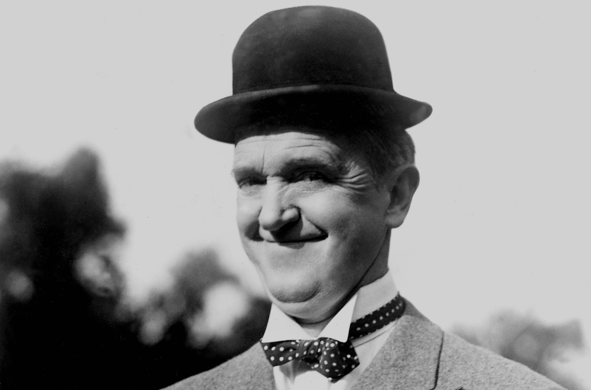 Stan Laurel in suit and a hat