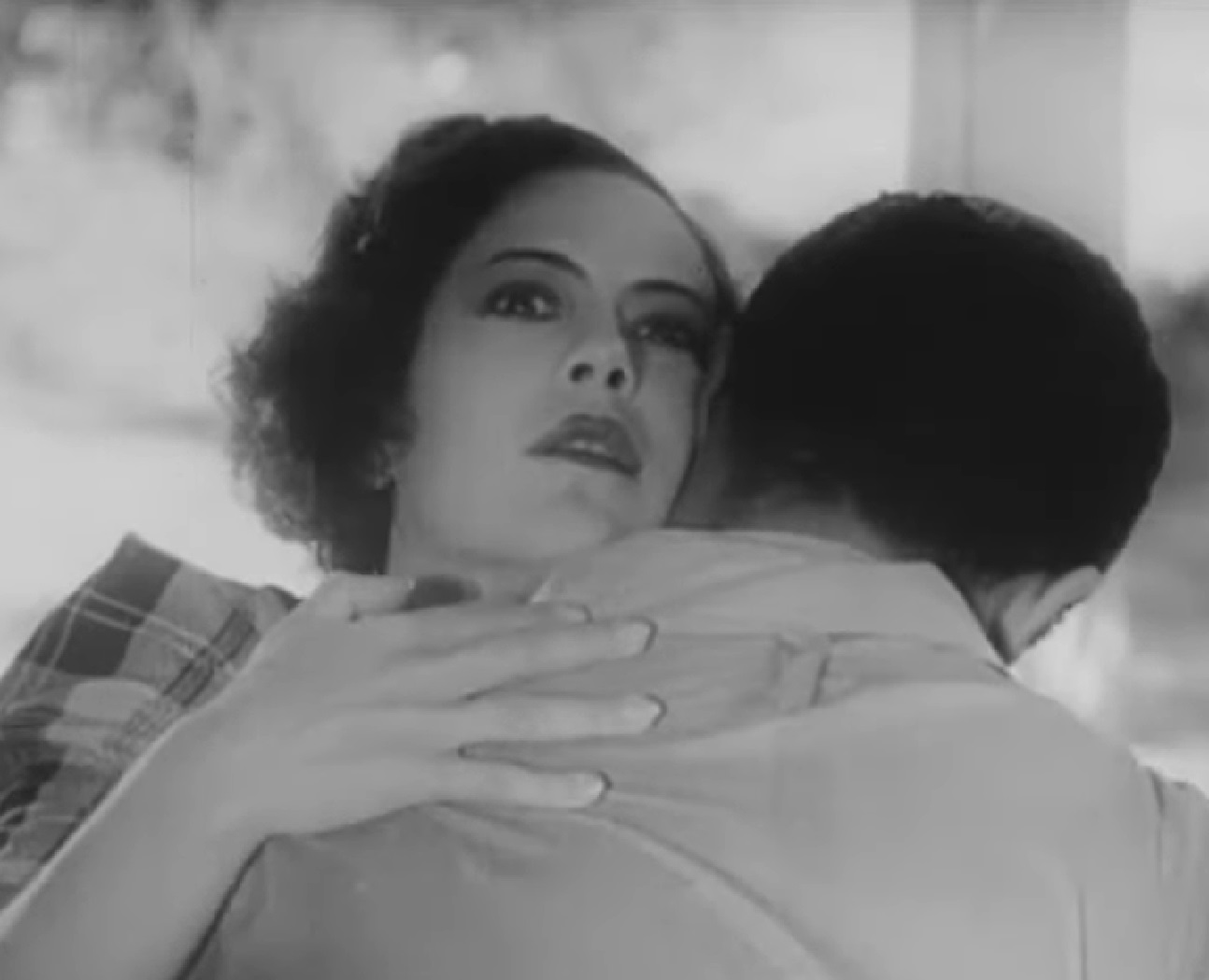 Screenshot of Fredi Washington hugging man - from Ouanga (1936)