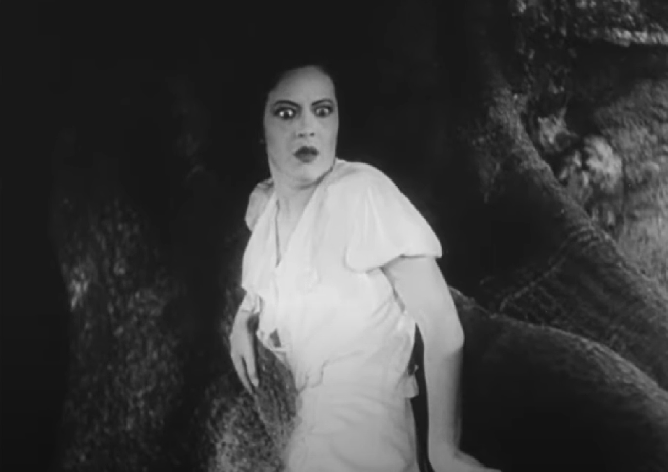 Screenshot of Fredi Washington in white dress looking upset - from Ouanga (1936)