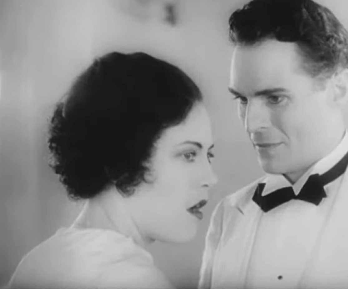Screenshot of Fredi Washington talking with man - from Ouanga (1936)