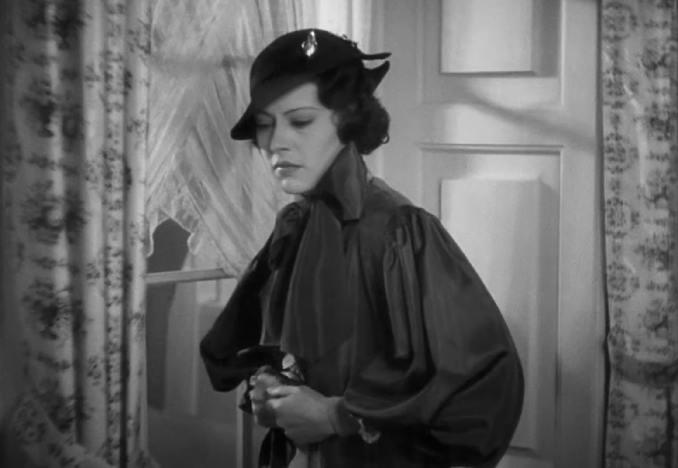 Screenshot of Fredi Washington in black coat is looking sad - from Imitation of Life (1934)