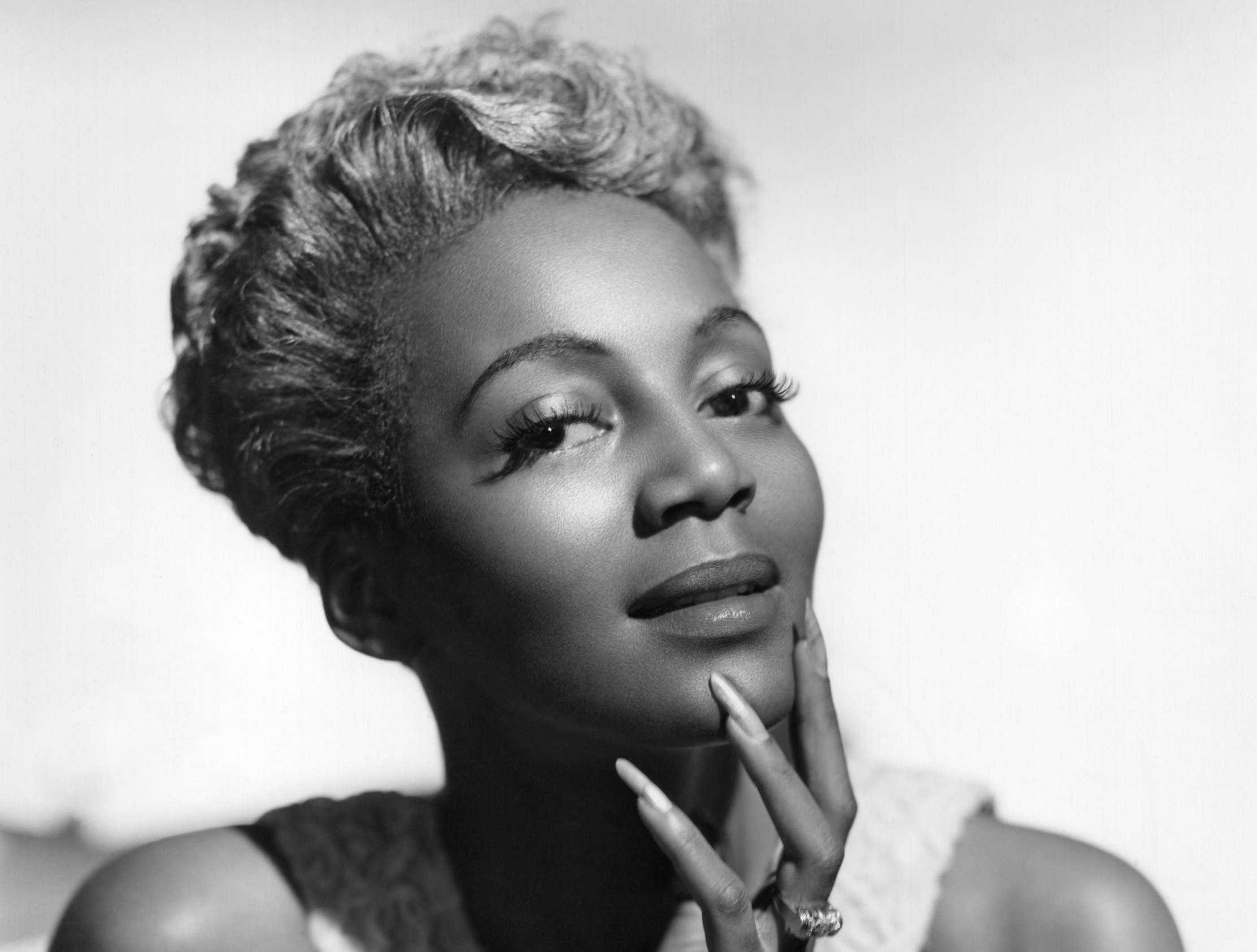 Actress and Singer Joyce Bryant models her signature silver hair and mermaid dress - 1953