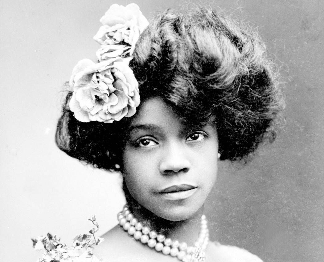 Aida Overton Walker, studio shot in wearing jewels and flowers in hair