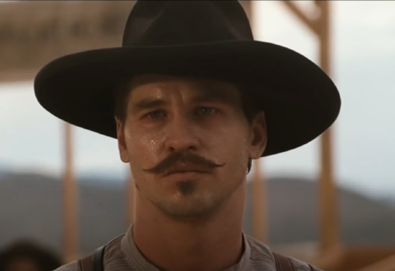 Screenshot of Val Kilmer with hat looking at camera - from Tombstone (1993)