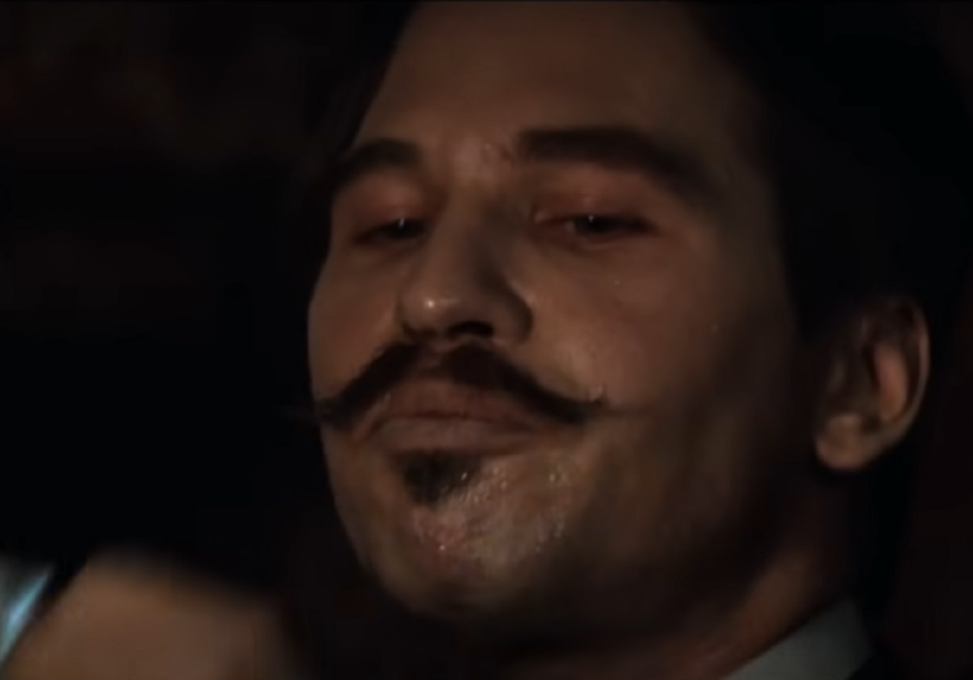 Screenshot of Val Kilmer looking at front - from Tombstone (1993)