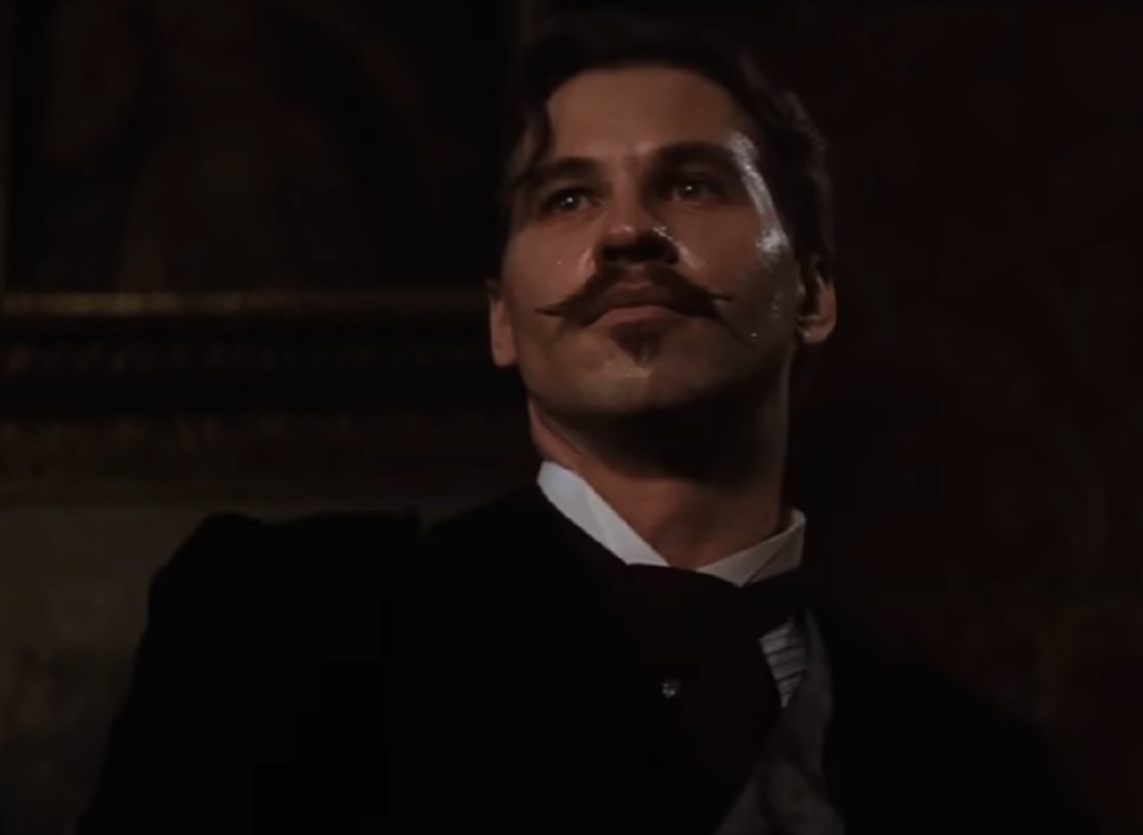 Screenshot of Val Kilmer looking at camera - from Tombstone (1993)