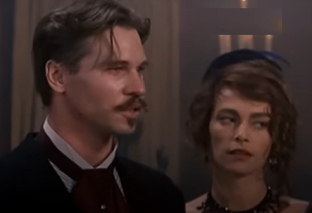 Screenshot of Val Kilmer standing in saloon next to a woman - from Tombstone (1993)