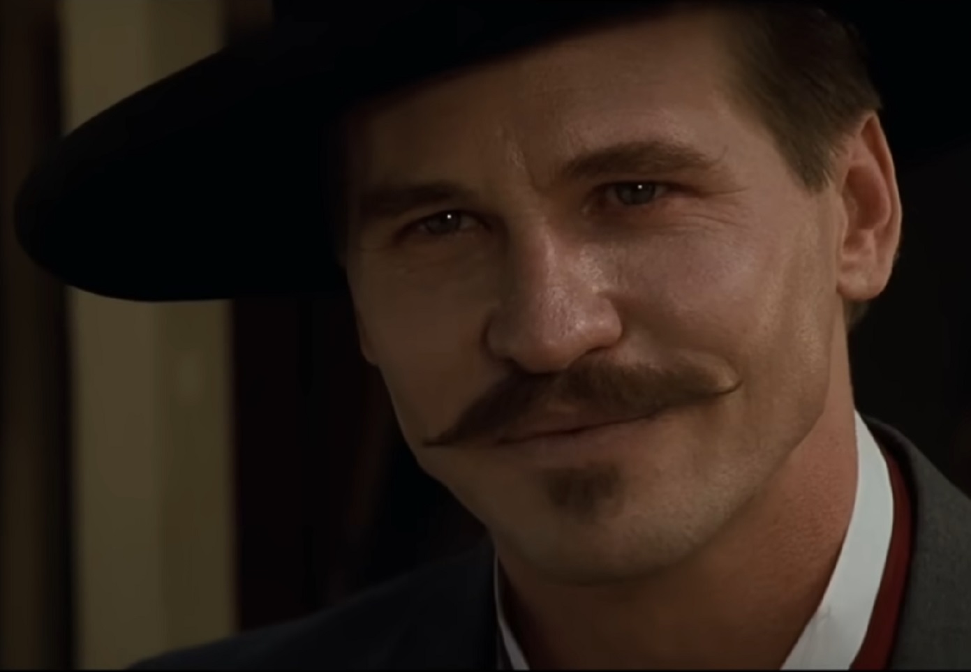 Screenshot of Val Kilmer with hat looking at camera - from Tombstone (1993)