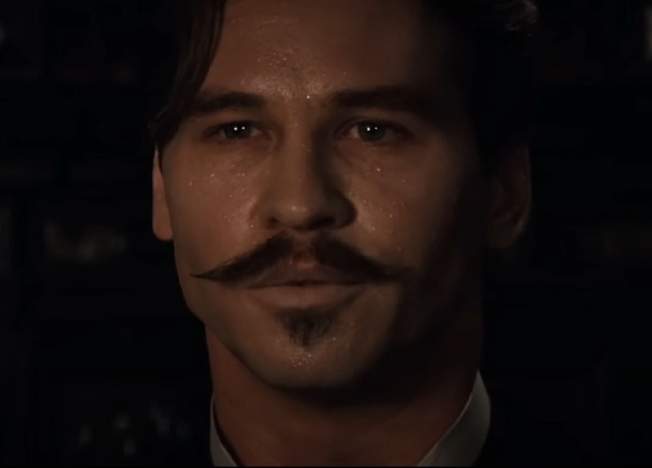 Screenshot of Val Kilmer looking at side - from Tombstone (1993)