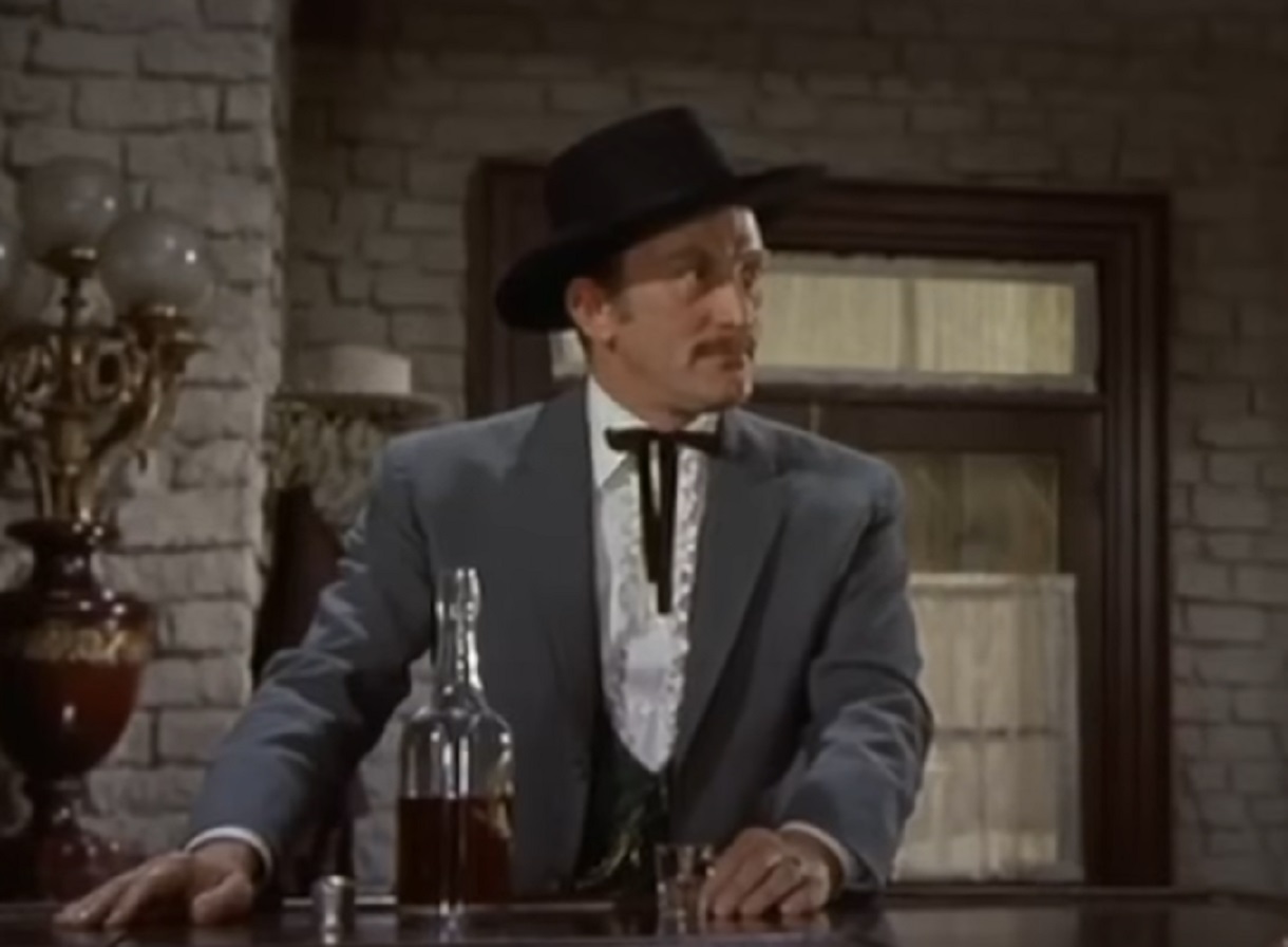 Screenshot of Kirk Douglas in Saloon looking at side - from Gunfight at the O.K. Corral (1957)